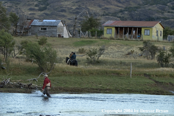 Flyfisherman on river.  Horseback rider in background.