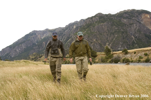 Flyfishermen walking from river. 