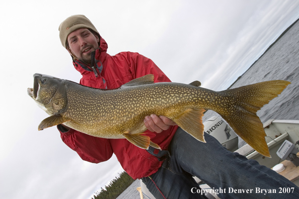 Fisherman with lake trout (MR).