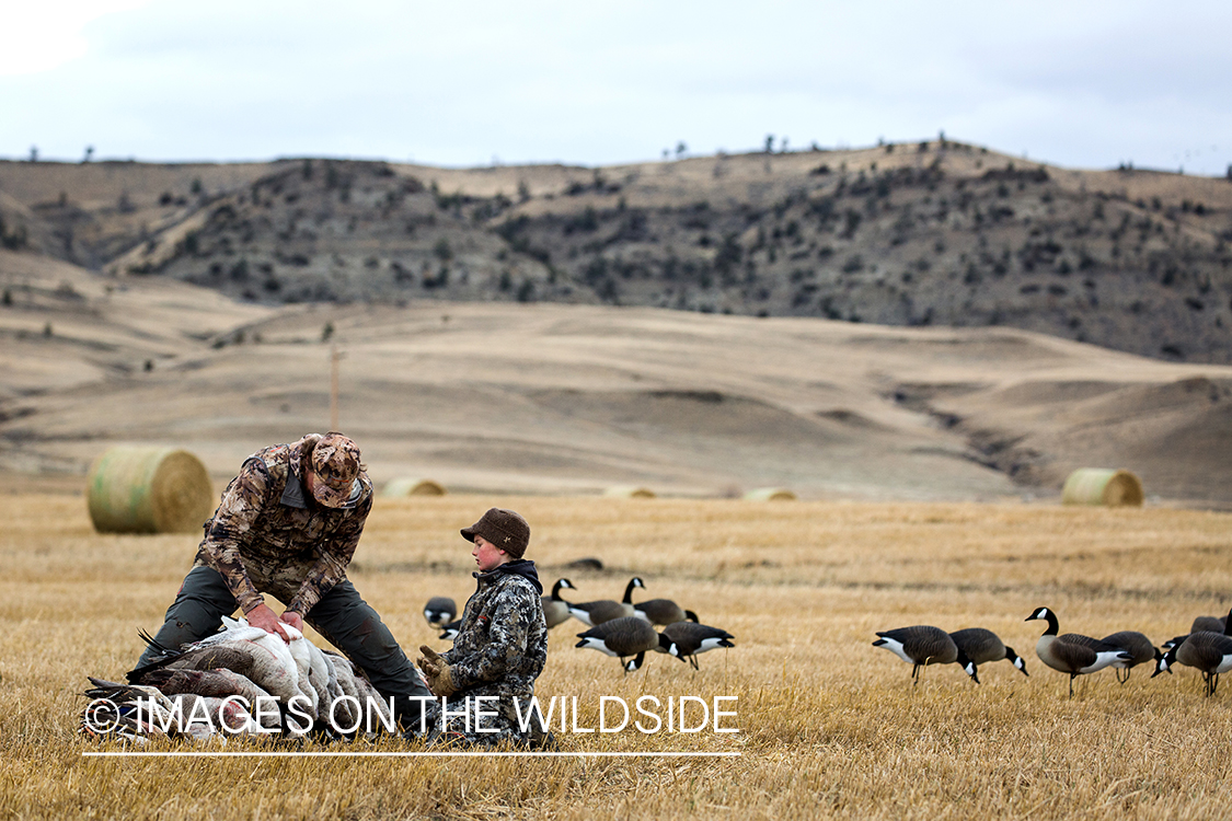 Father and son with bagged waterfowl.