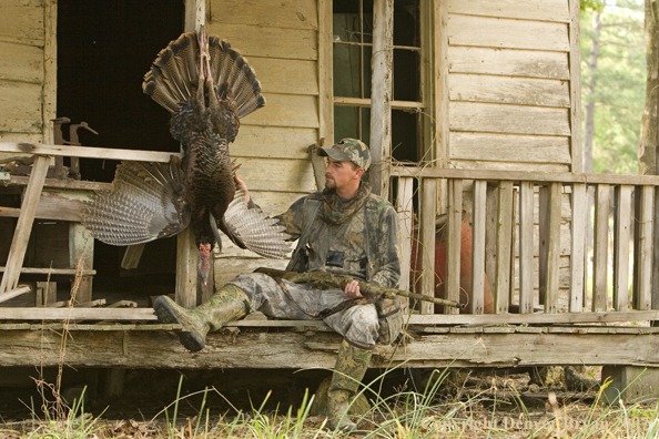 Turkey hunter in field with bagged bird