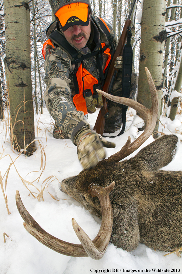 Hunter with bagged white-tailed deer.