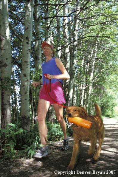 Woman running with golden Retriever