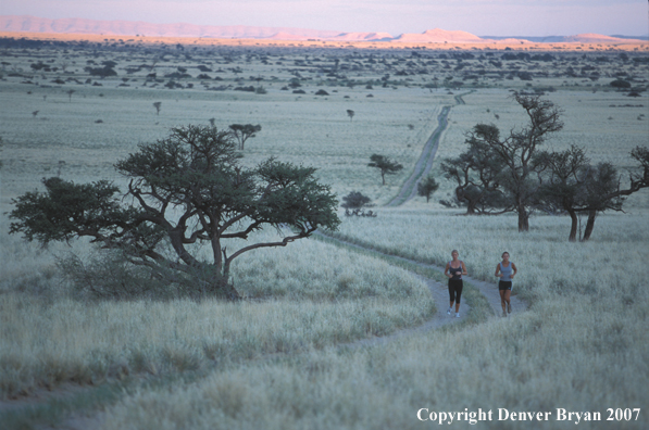 Women running on road, Namibia. Africa.