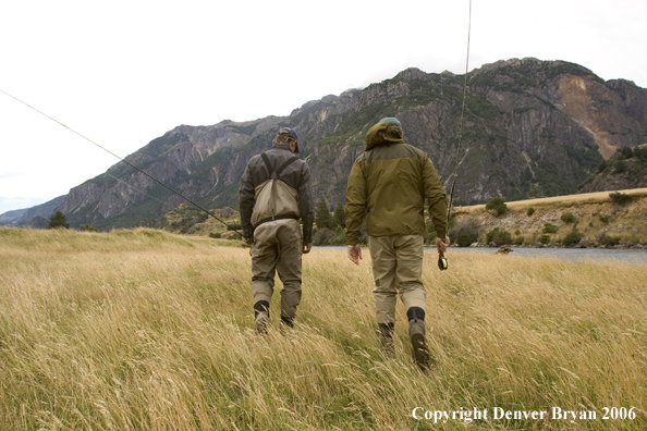 Flyfishermen walking to river. 