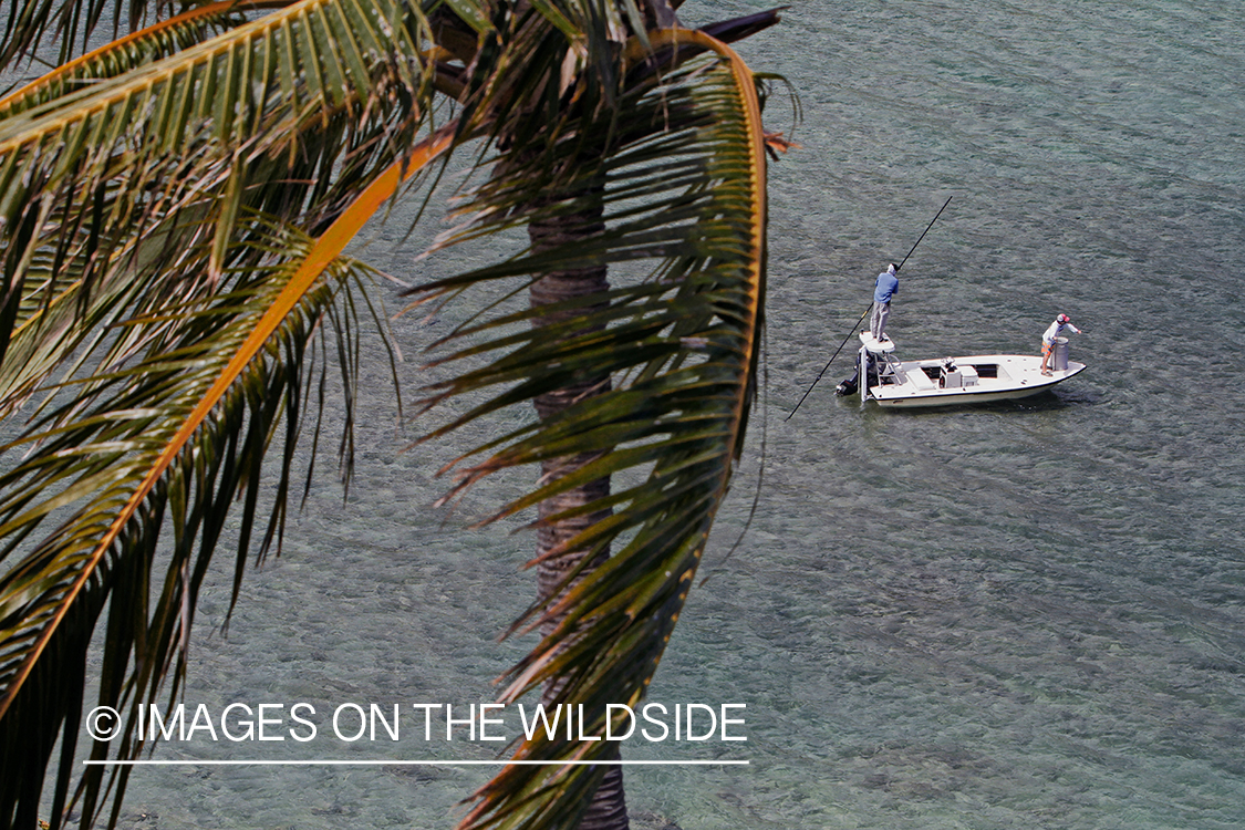 Saltwater flyfishermen fishing on flats boat.