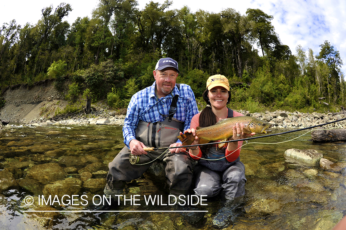 Flyfishing man and woman with trout.