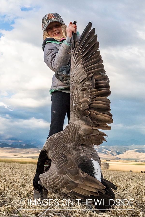 Young hunter with bagged goose. 