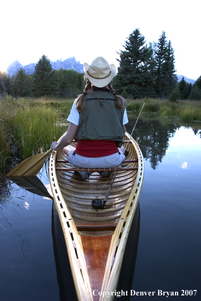 Woman in wooden canoe