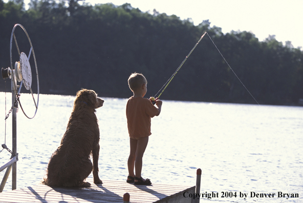 Golden Retriever with young child fishing.