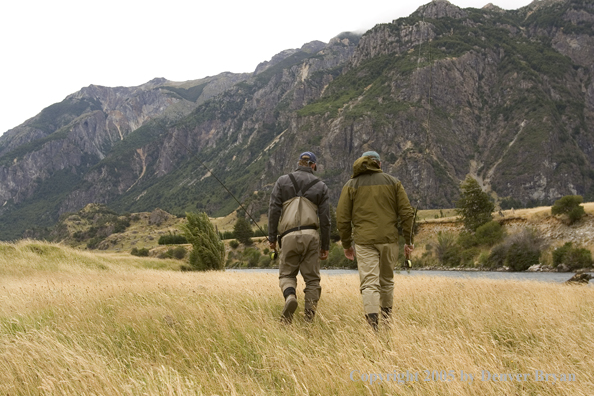 Flyfishermen walking to river. 