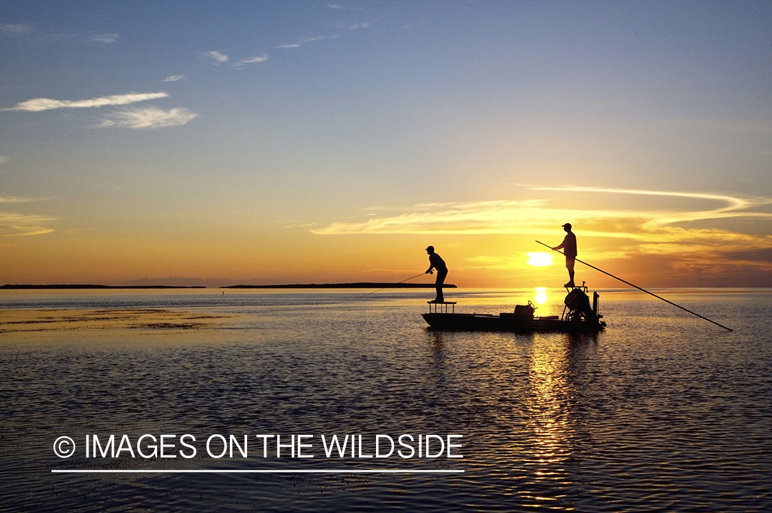 Flyfisherman casting from boat during sunset.