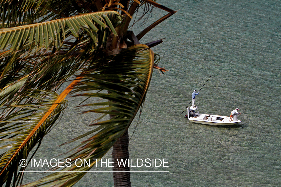 Saltwater flyfishermen fishing on flats boat.