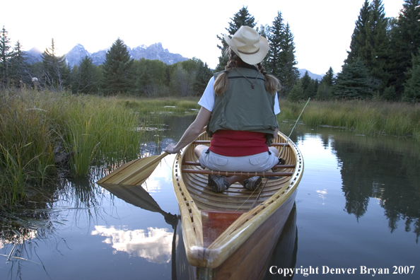 Woman in wooden canoe