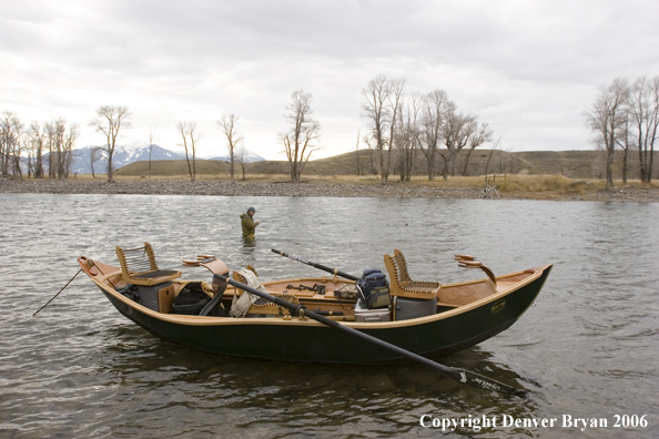 Flyfisherman in background of boat fishing.