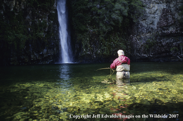 Angler casts under falls