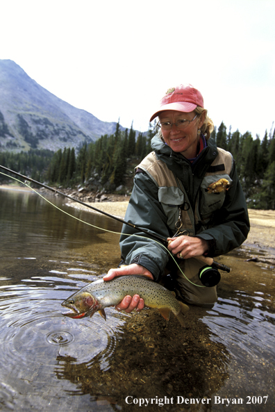 Flyfisher with cutthroat trout.