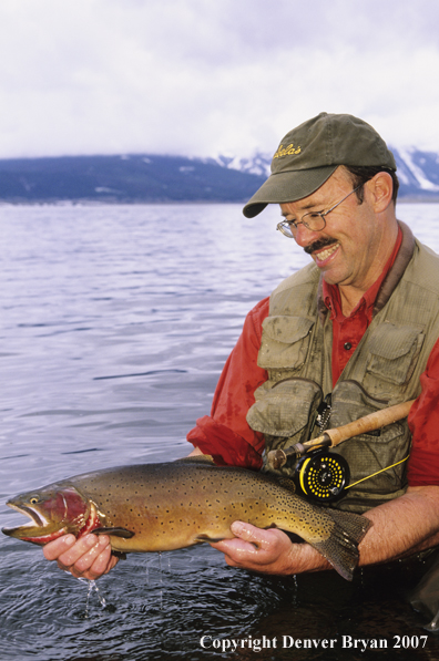 Flyfisherman with large cutthroat trout.