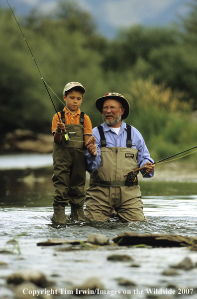 Grandfather teaching grandson how to fish