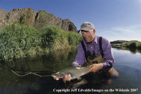 Flyfisherman with a nice Rainbow Trout