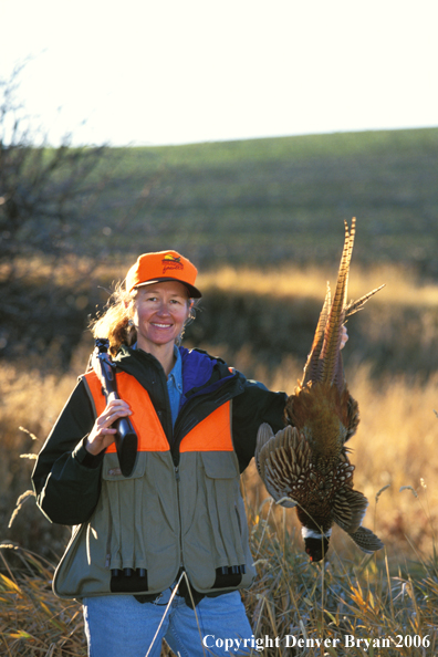 Upland game bird hunter with bagged pheasant.