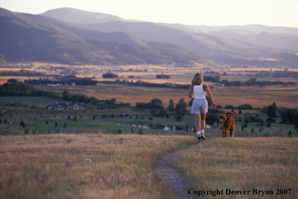 Woman running with golden Retriever