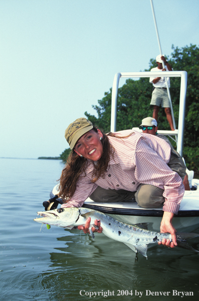 Saltwater flyfisher holding barricuda.