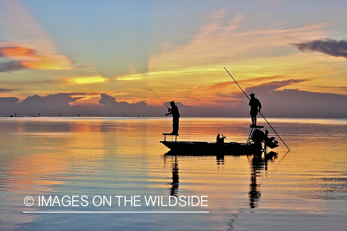 Flyfisherman casting from boat during sunset.