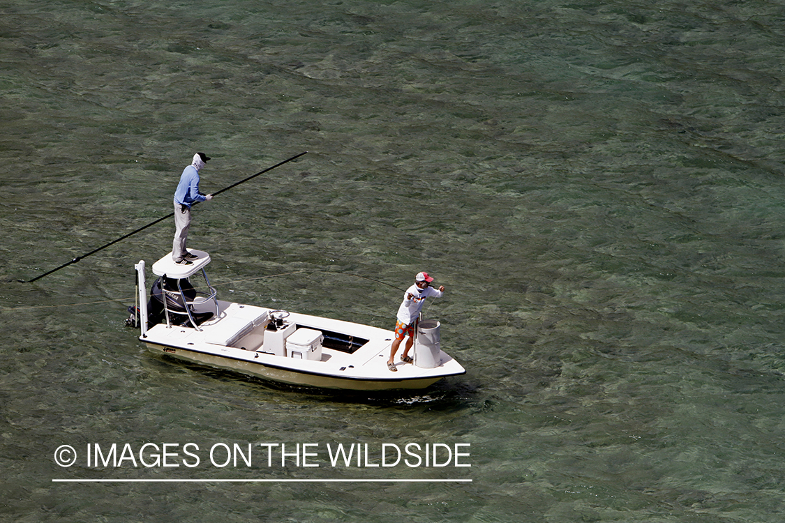 Saltwater flyfishermen fishing on flats boat.