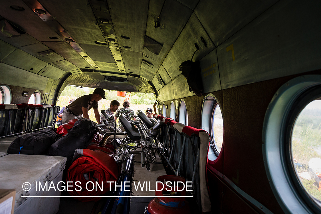 Flyfishermen inside Russian helicopter in Kamchatka Peninsula, Russia.