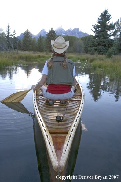 Woman in wooden canoe