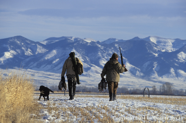 Waterfowl hunters with ducks and Lab.