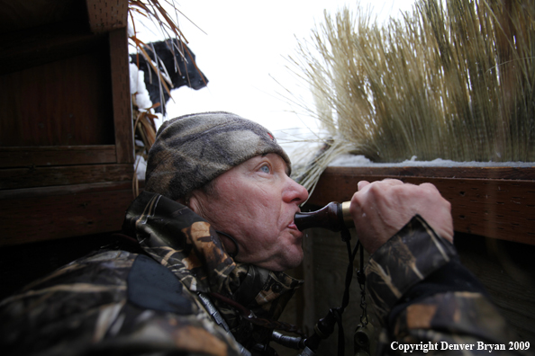 Waterfowl hunter with duck call.