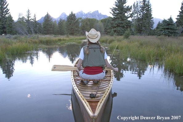 Woman in wooden canoe