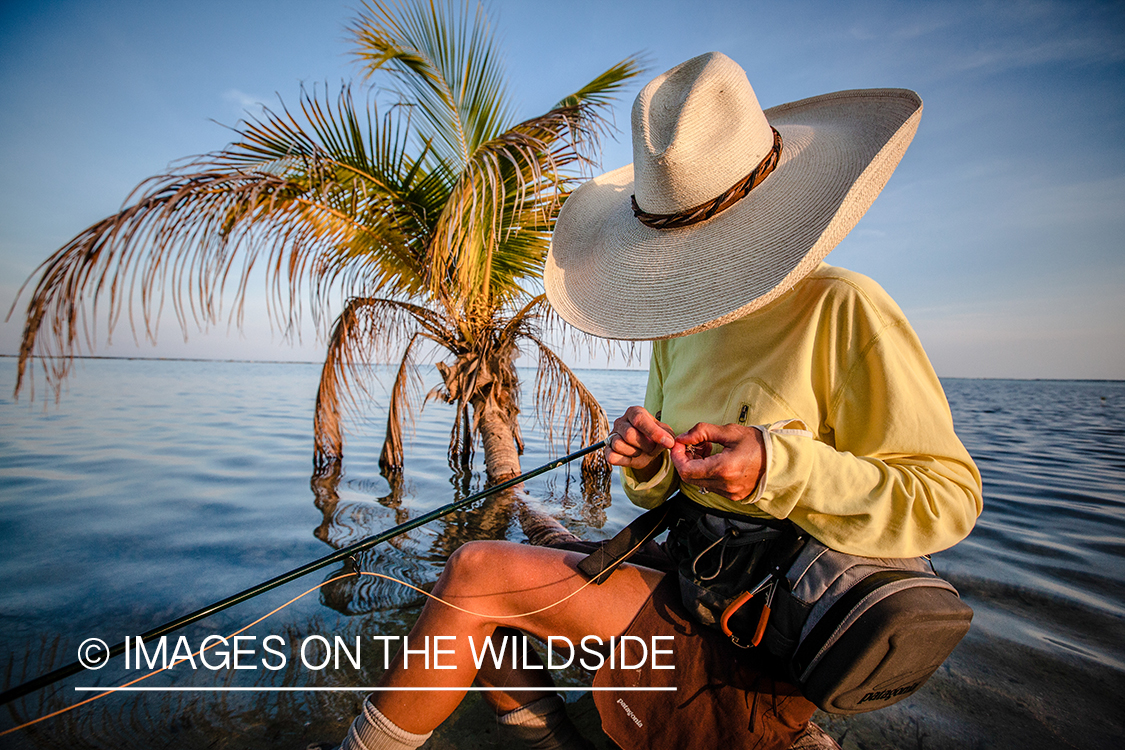 Flyfishing woman tying fly.