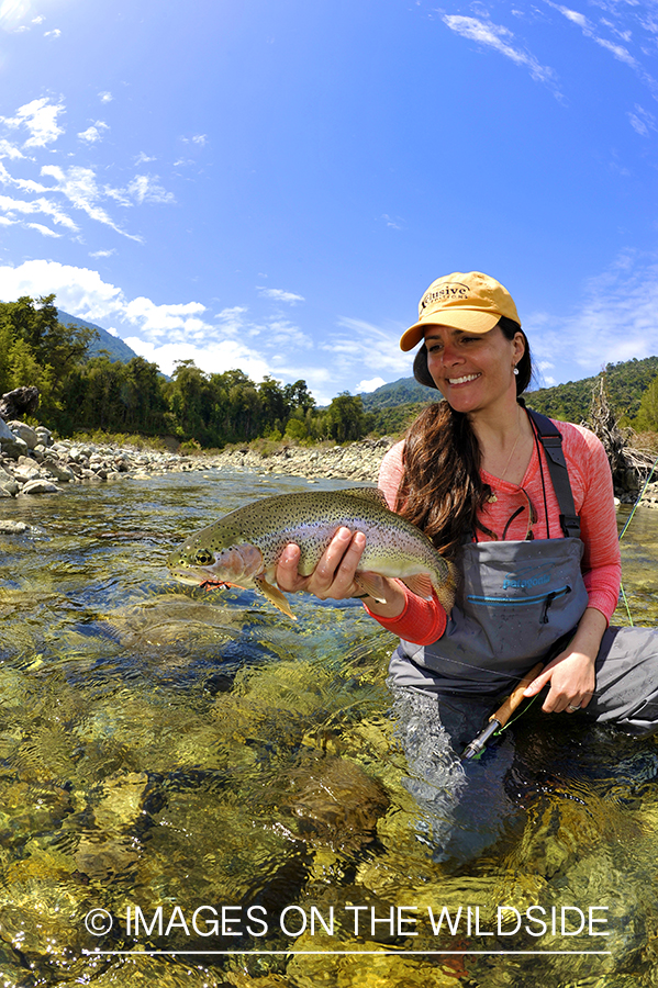 Flyfishing woman with rainbow.
