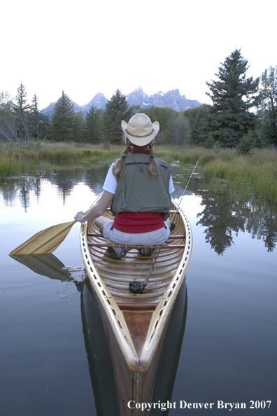 Woman in wooden canoe