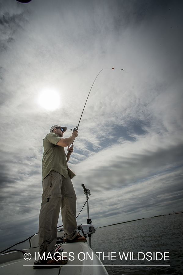 Fisherman casting line.