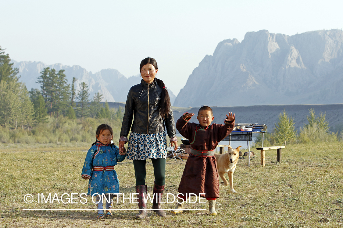 Mongolian woman with children in native dress along the Delger River, Mongolia.