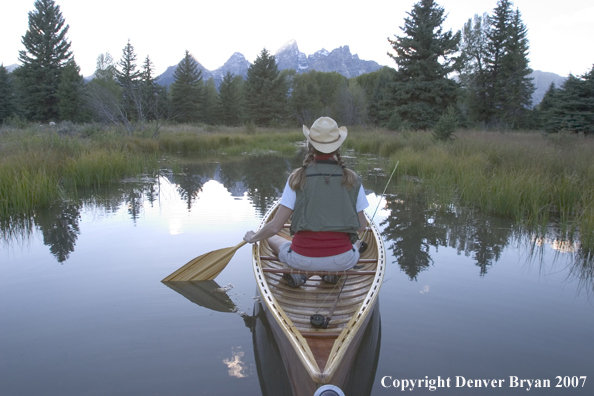 Woman in wooden canoe