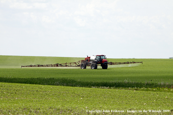 Farmer working field near wetlands