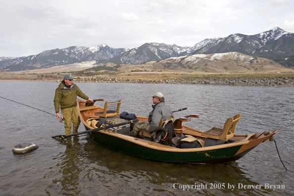 Flyfishermen and black Labrador Retriever in driftboat on Yellowstone River, Montana.