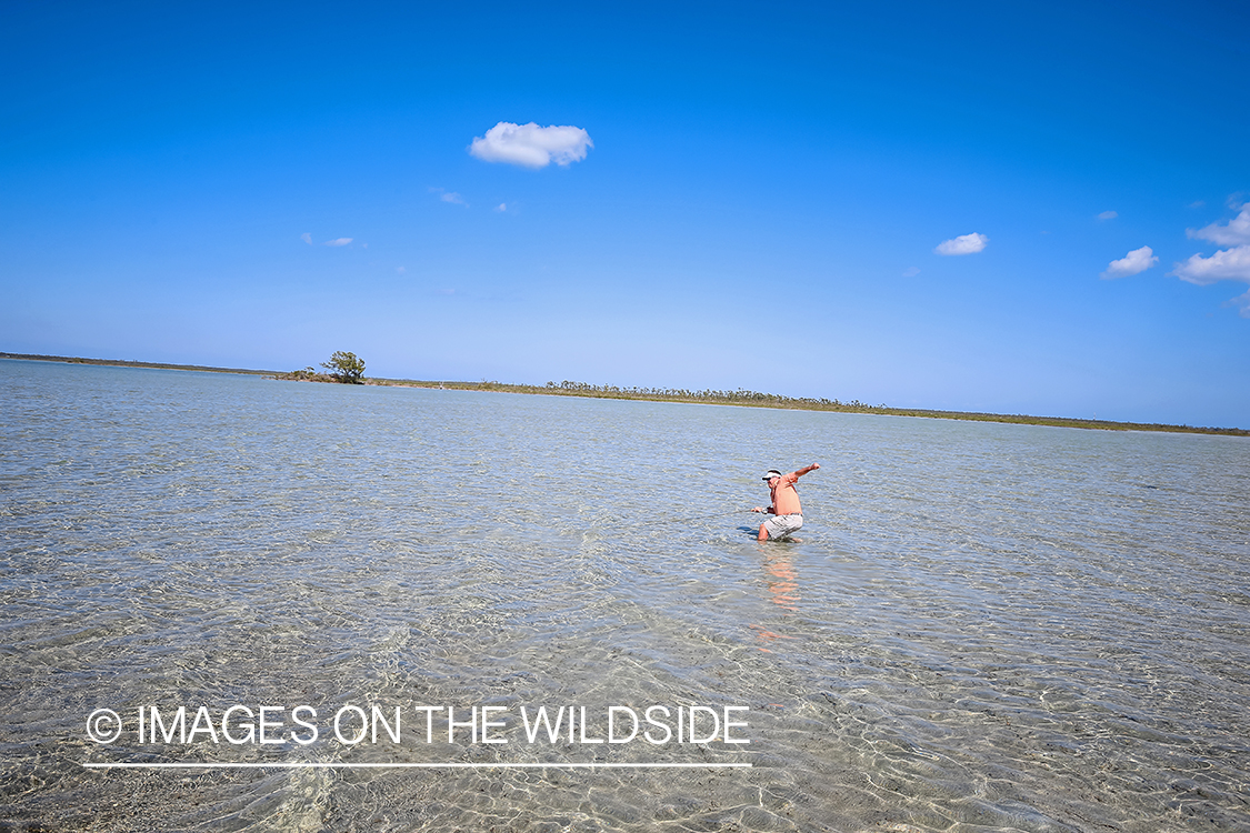 Flyfisherman fighting bonefish.