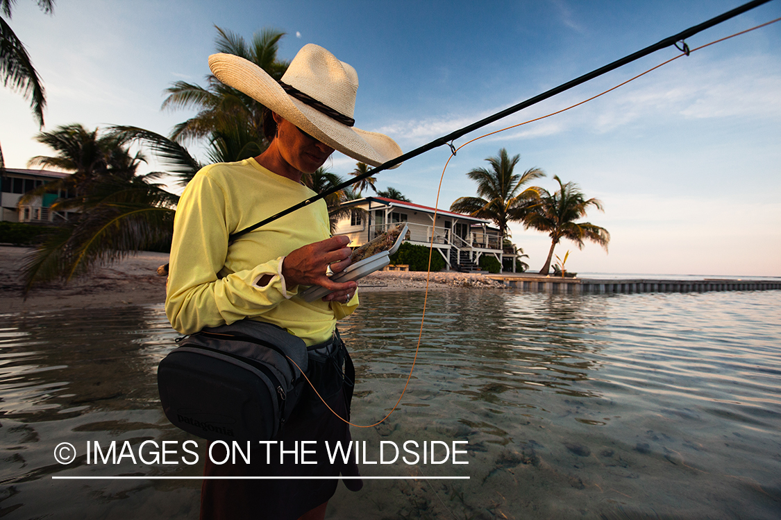 Flyfishing woman tying fly.