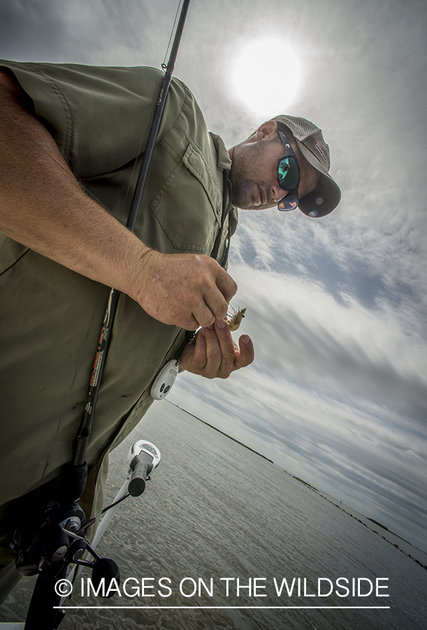 Fisherman putting bate on hook.