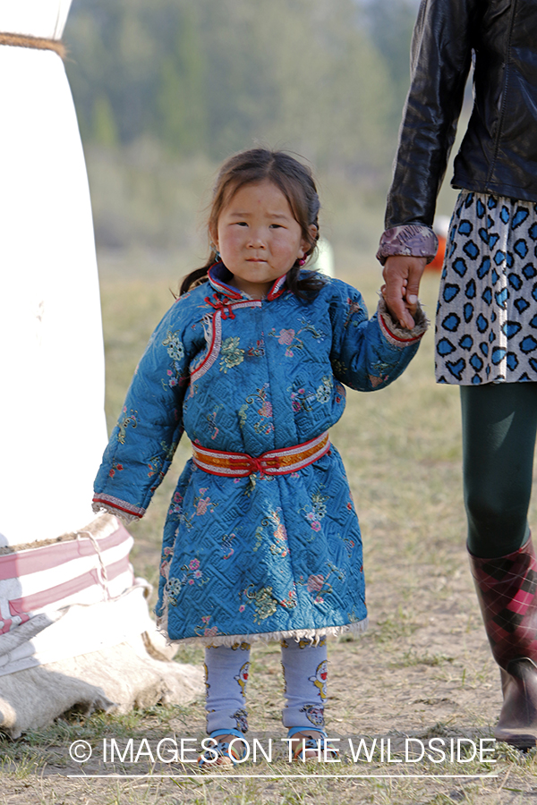 Mongolian girl in native dress along Delger River, Mongolia.