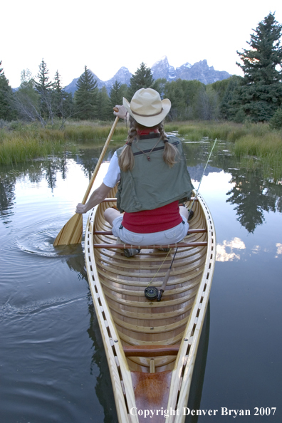 Woman in wooden canoe