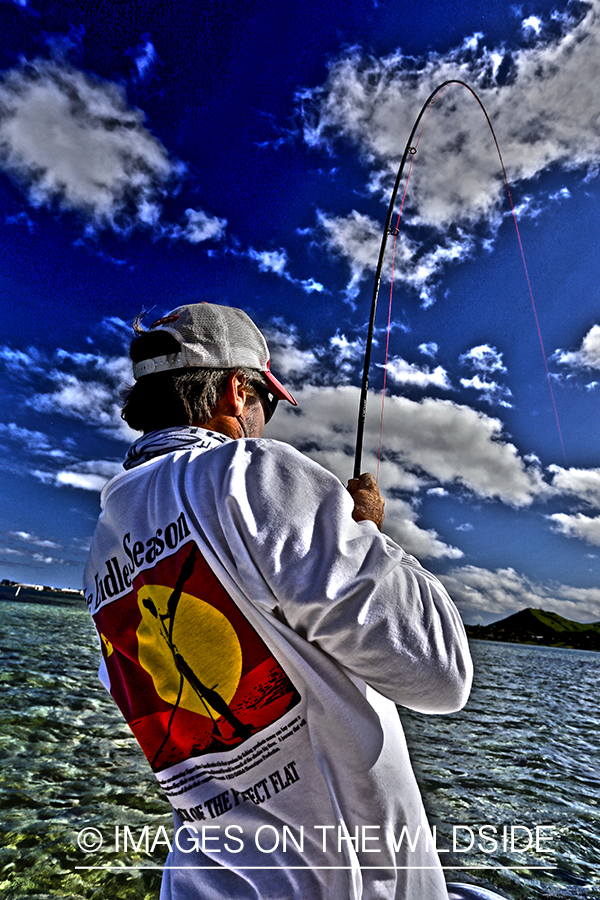 Saltwater flyfisherman fishing on flats boat, in Hawaii. (HDR)