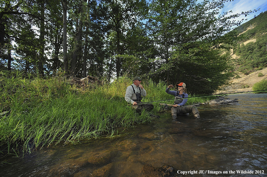 Flyfishers on river.