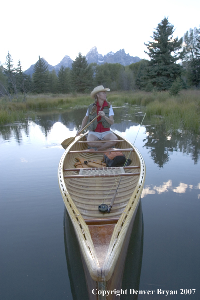 Woman in wooden canoe